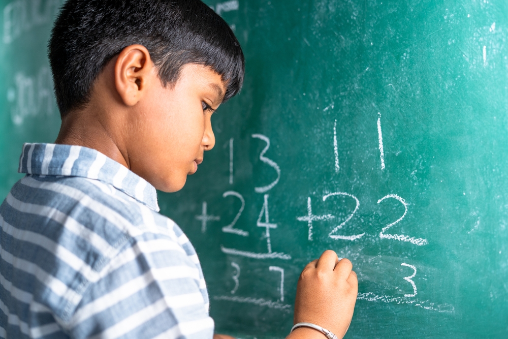 Student doing math on blackboard